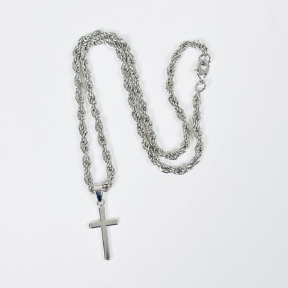 Silver chain necklace with a cross pendant on a white background