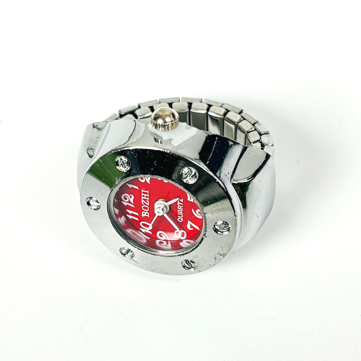 A silver-tone metal watch with a cylindrical bezel, rhinestone accents, and a bold red dial featuring white Arabic numerals and the brand name BOZHI.