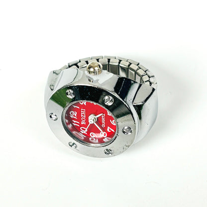 A silver-tone metal watch with a cylindrical bezel, rhinestone accents, and a bold red dial featuring white Arabic numerals and the brand name BOZHI.