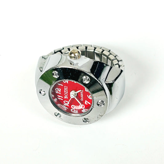 A silver-tone metal watch with a cylindrical bezel, rhinestone accents, and a bold red dial featuring white Arabic numerals and the brand name BOZHI.