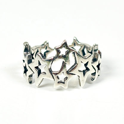 A sterling silver band ring featuring a series of interlocking star cutouts, photographed on a seamless white background.