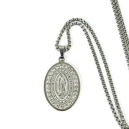 Silver oval Miraculous Medal pendant necklace with clear rhinestone border, shown on a white background with a silver chain.