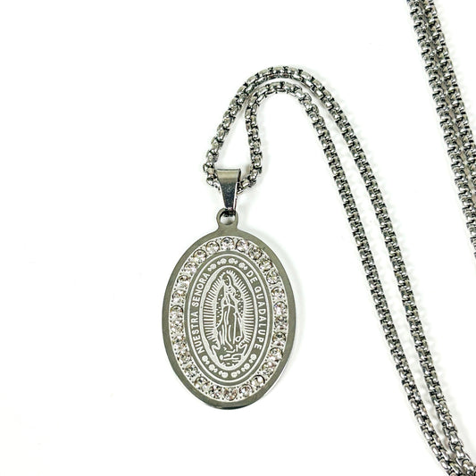 Silver oval Miraculous Medal pendant necklace with clear rhinestone border, shown on a white background with a silver chain.