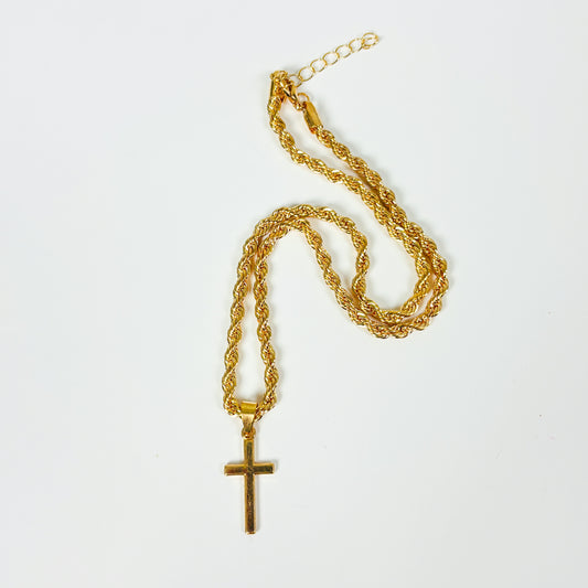 Gold chain necklace with a cross pendant on a white background