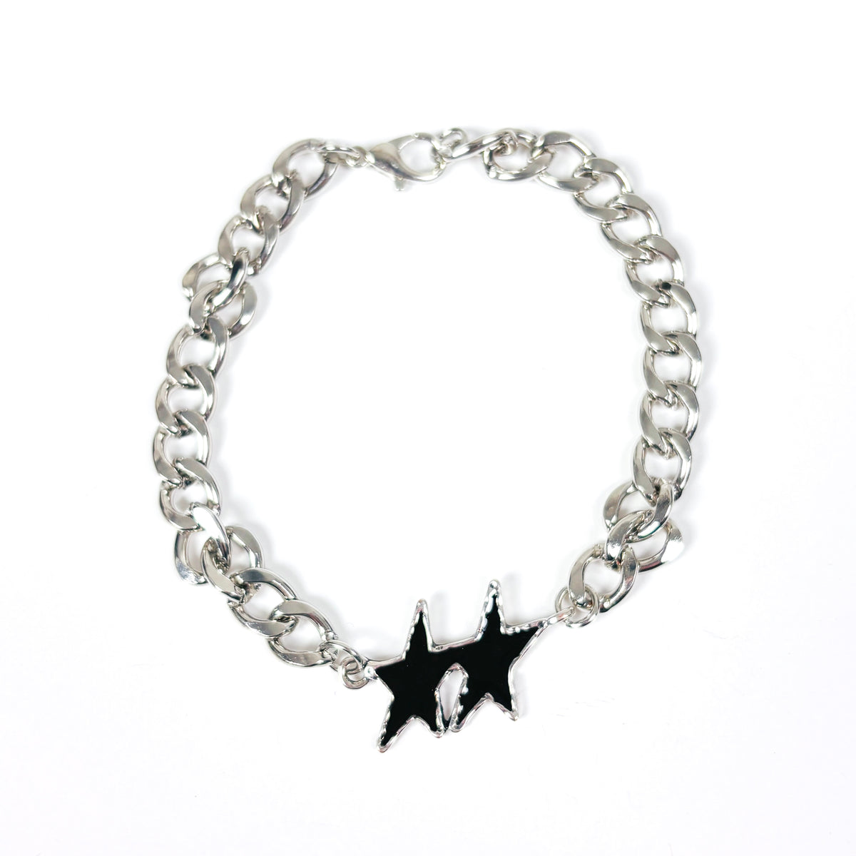 A silver-tone metal chain bracelet with a black enamel starburst charm featuring a small white skull detail in the center, displayed on a clean white background.