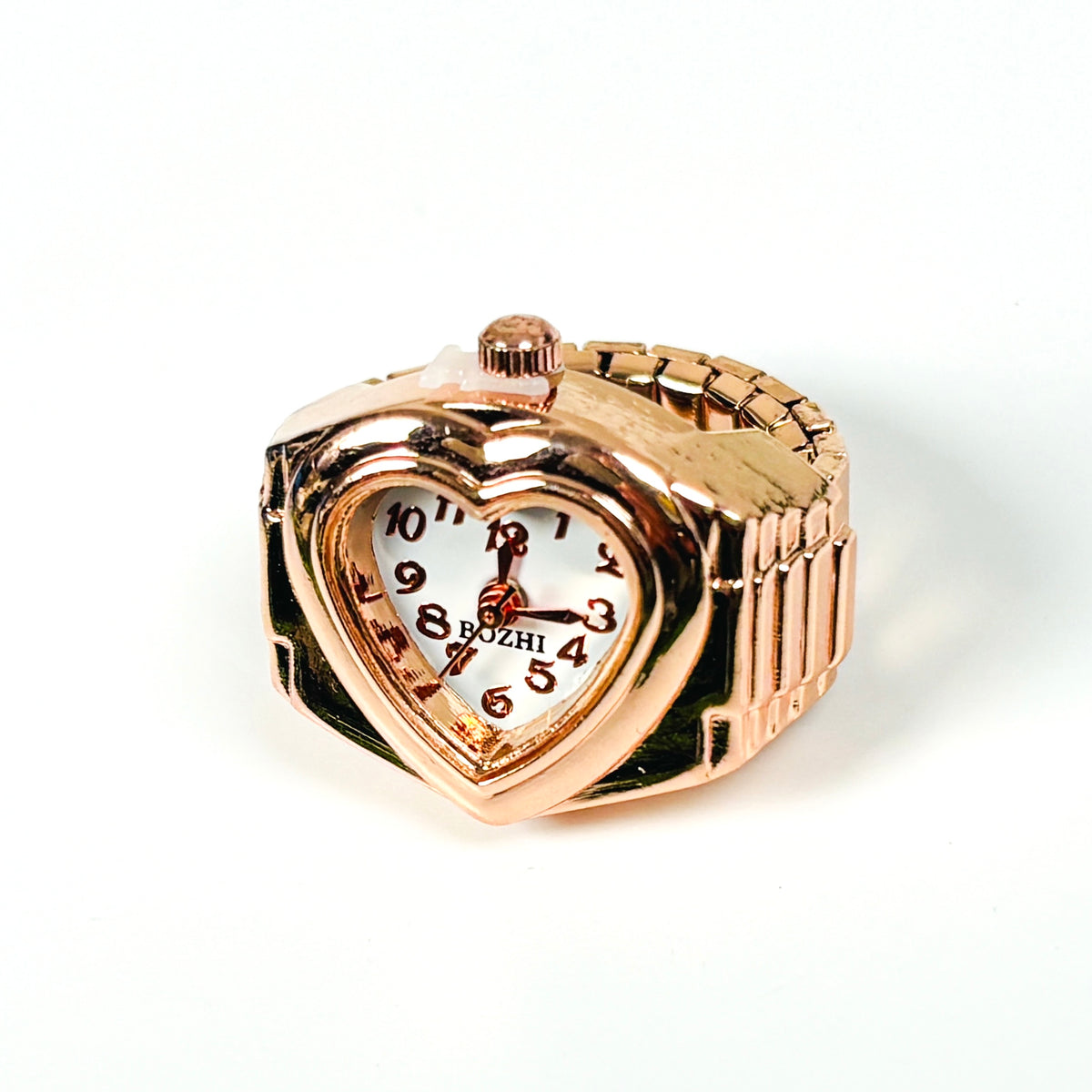 A heart-shaped rose gold watch with a white dial and black Arabic numerals, featuring a matching rose gold link band, photographed on a white background.