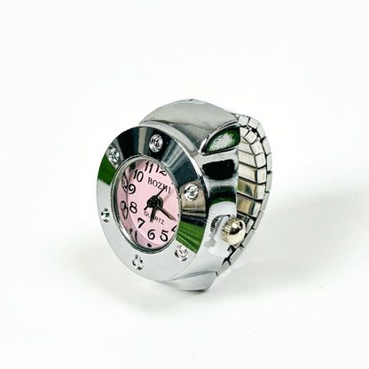 A silver-tone metal watch with a pink dial and rhinestone accents, photographed on a plain white background.