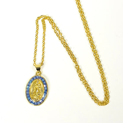 Gold chain necklace with an oval religious pendant featuring a gold figure surrounded by blue rectangular accents, displayed on a white background.