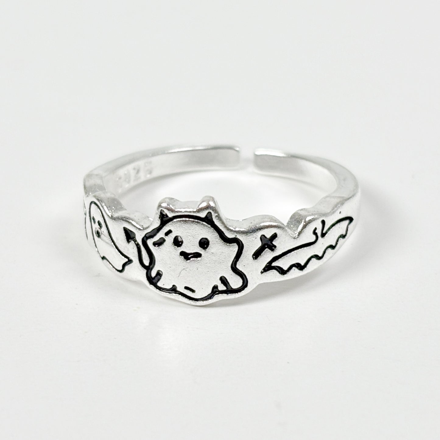Silver ring with a ghost design on a white background