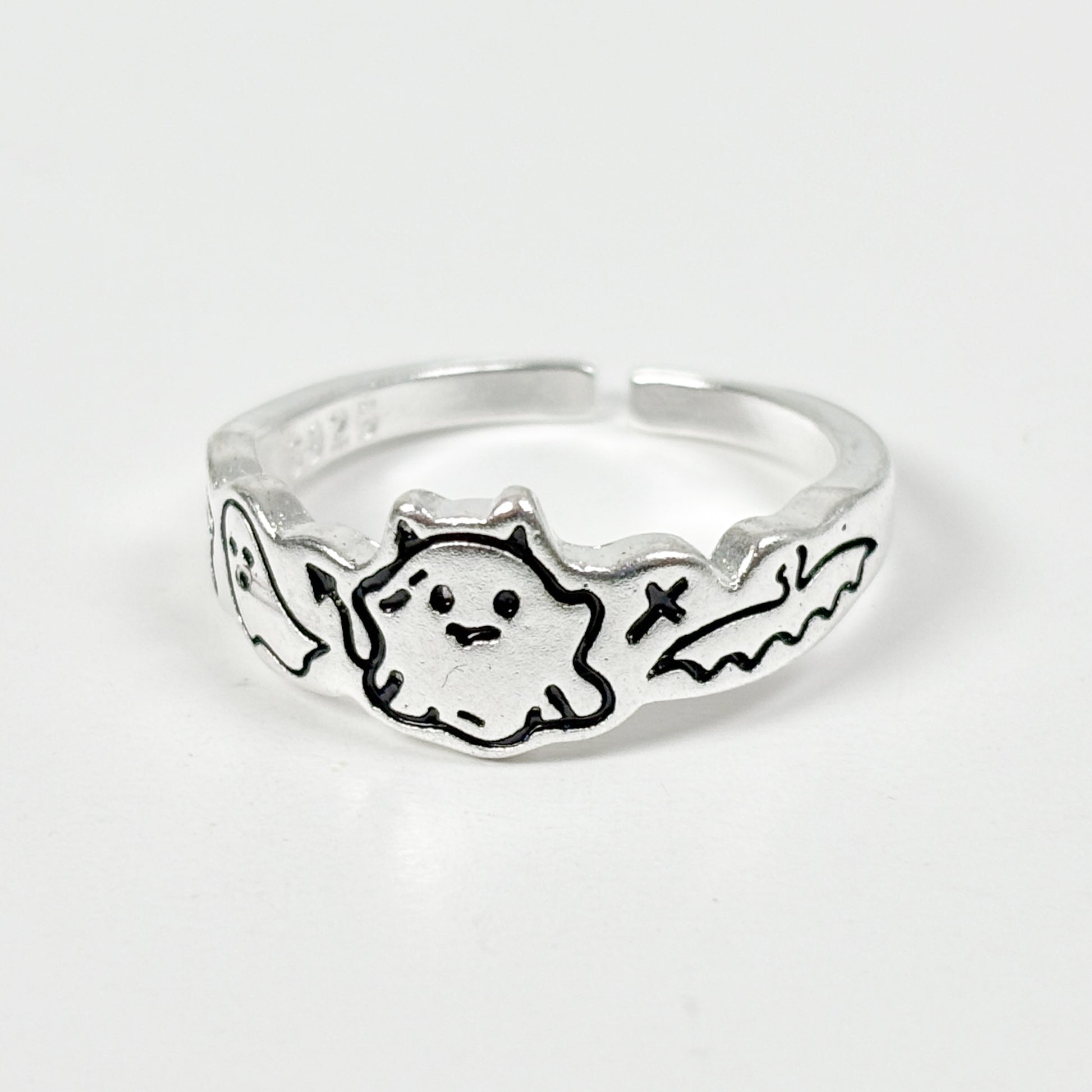 Silver ring with a ghost design on a white background