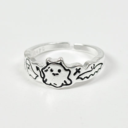 Silver ring with a ghost design on a white background