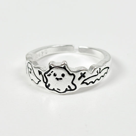 Silver ring with a ghost design on a white background