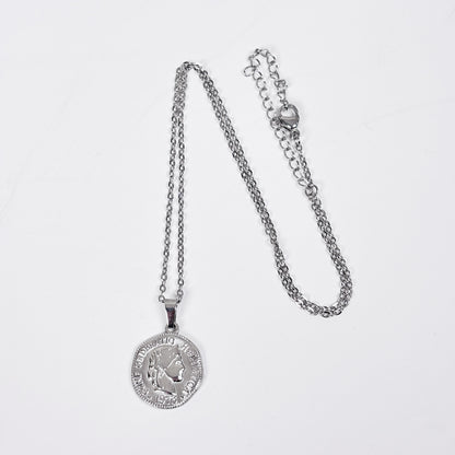 Silver necklace with a pendant on a light gray background