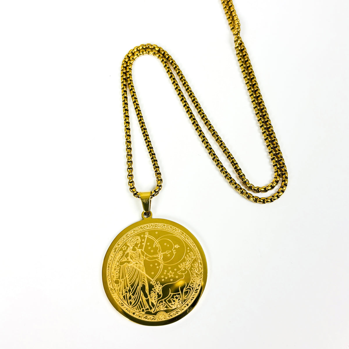 A gold pendant necklace featuring a circular medallion engraved with a celestial design of a crescent moon, stars, and a rabbit, suspended from a gold box chain on a white background.
